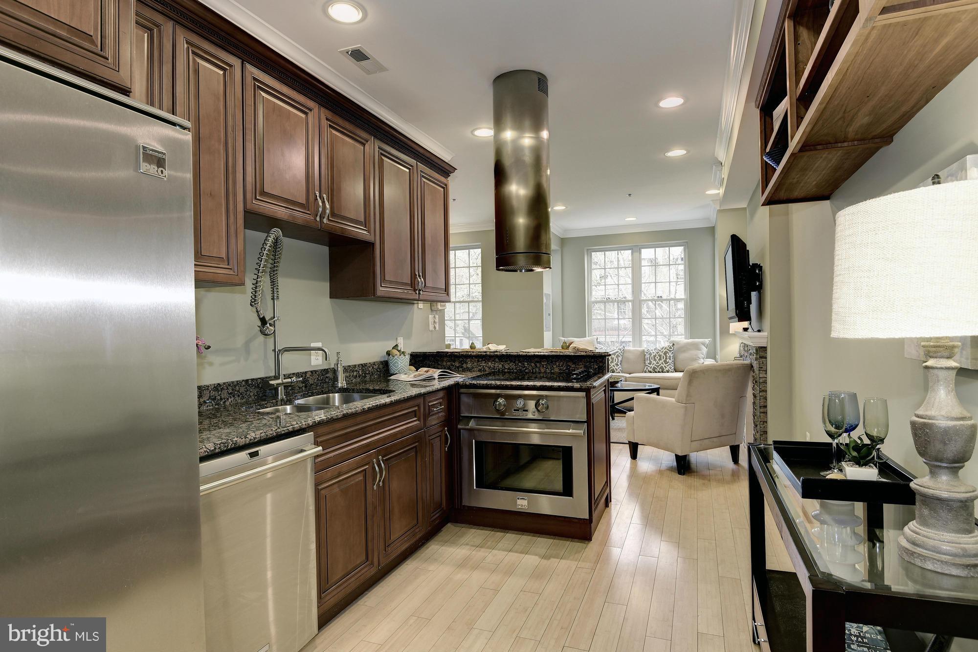 1126 Columbia Road Northwest, Unit 3 Washington, DC 20009 - Photo 9 of 23 a kitchen with stainless steel appliances granite countertop a stove a sink dishwasher and a refrigerator