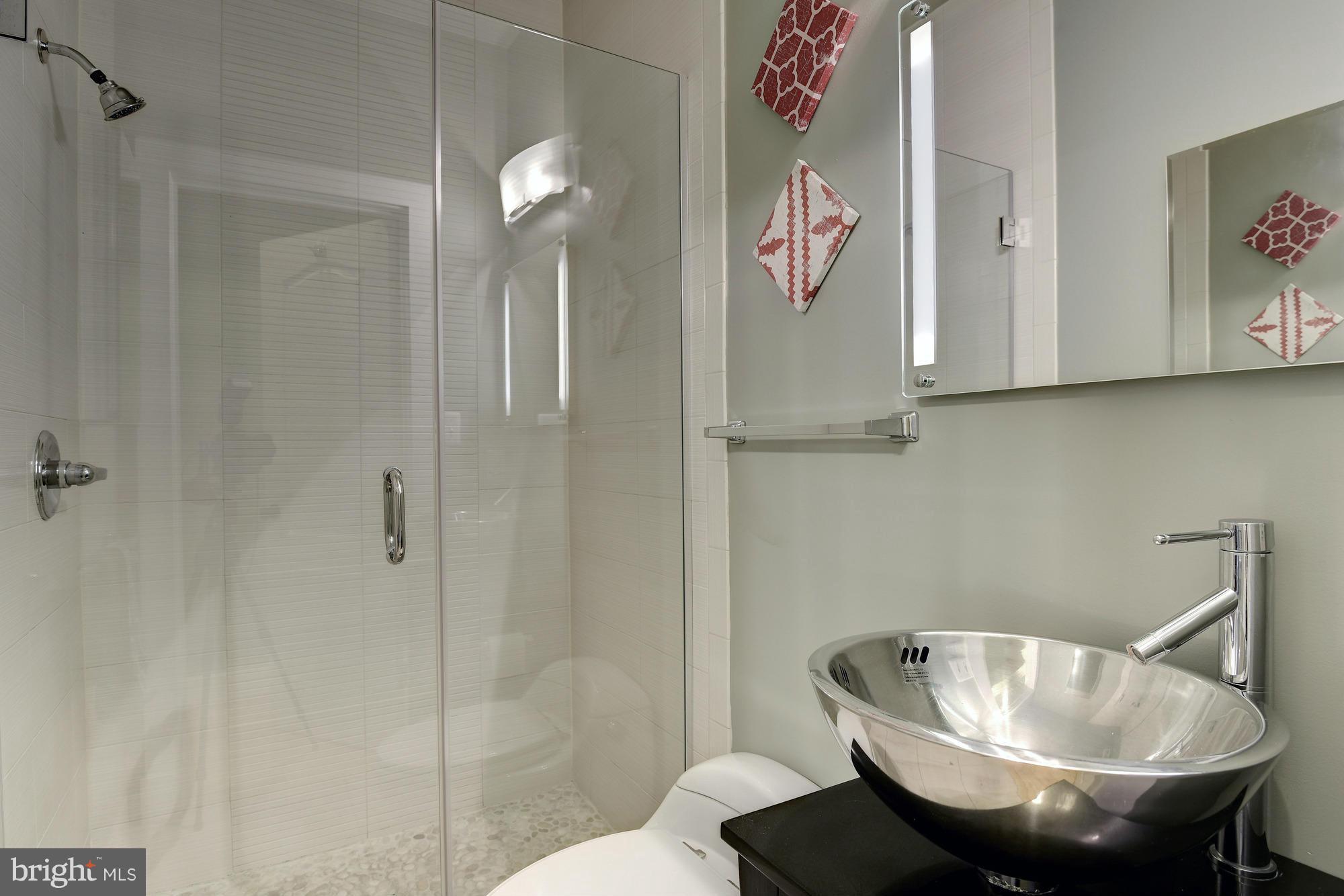 1126 Columbia Road Northwest, Unit 3 Washington, DC 20009 - Photo 10 of 23 a bathroom with a sink and a mirror