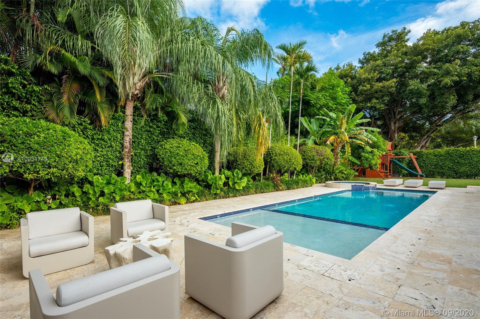 4301 Bay Point Road Miami, FL 33137 - Photo 1 of 33 a view of a couches in a patio with swimming pool