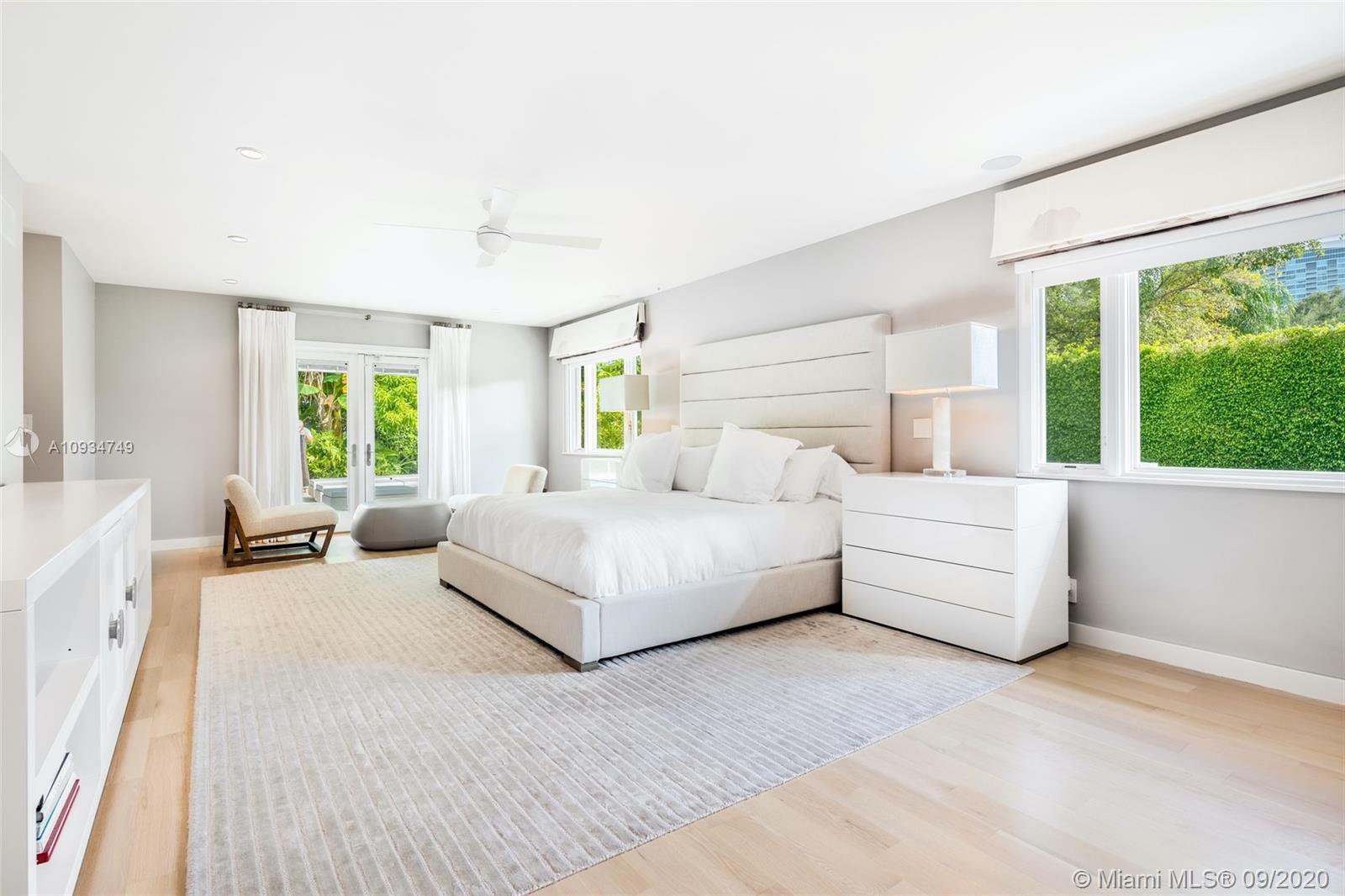 4301 Bay Point Road Miami, FL 33137 - Photo 17 of 33 a spacious bedroom with a large bed and a large window