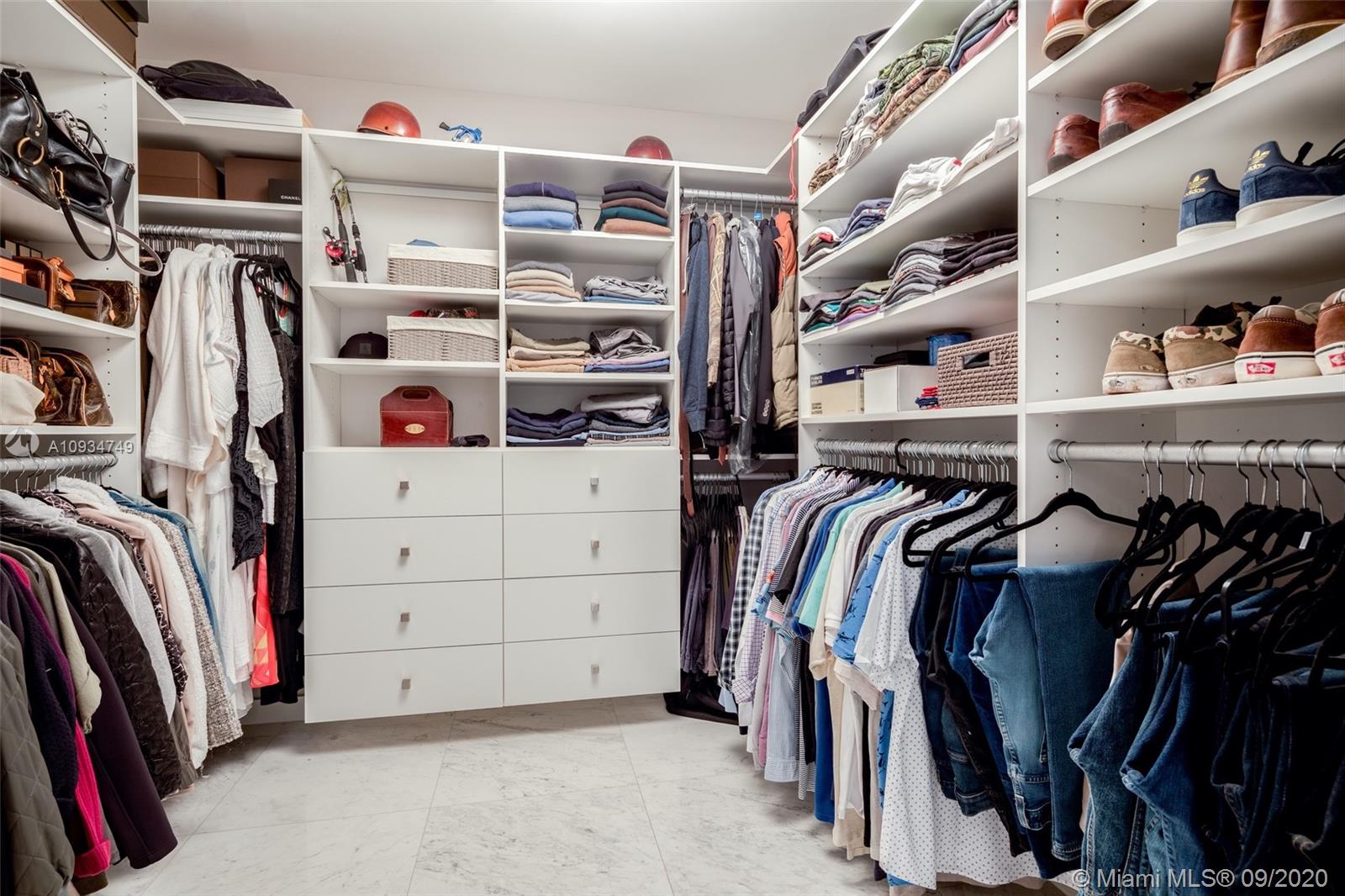 4301 Bay Point Road Miami, FL 33137 - Photo 21 of 33 a view of walk in closet with clothes and shoes