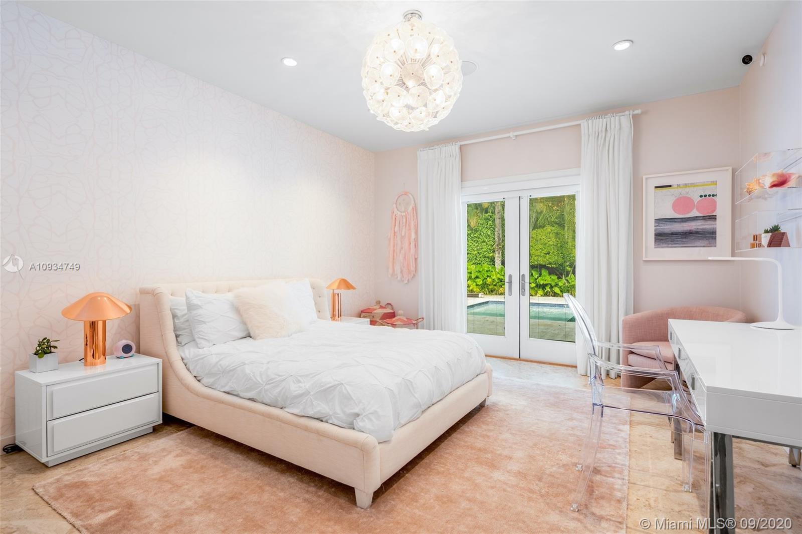 4301 Bay Point Road Miami, FL 33137 - Photo 24 of 33 a bedroom with a bed and a table