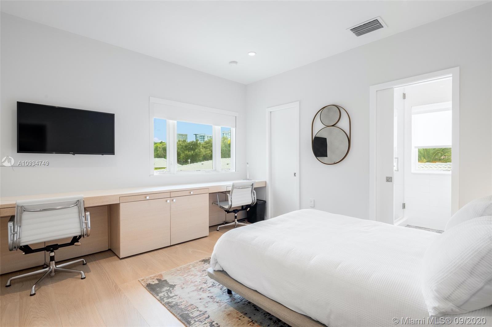 4301 Bay Point Road Miami, FL 33137 - Photo 26 of 33 a bedroom with a bed and a flat screen tv