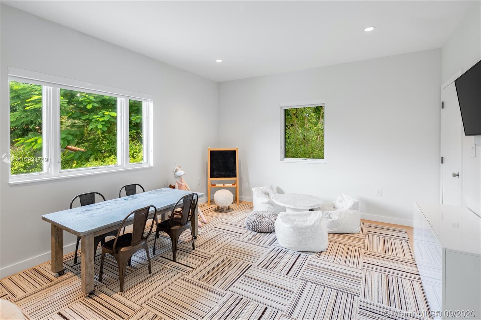 4301 Bay Point Road Miami, FL 33137 - Photo 27 of 33 a living room with a couch and a window