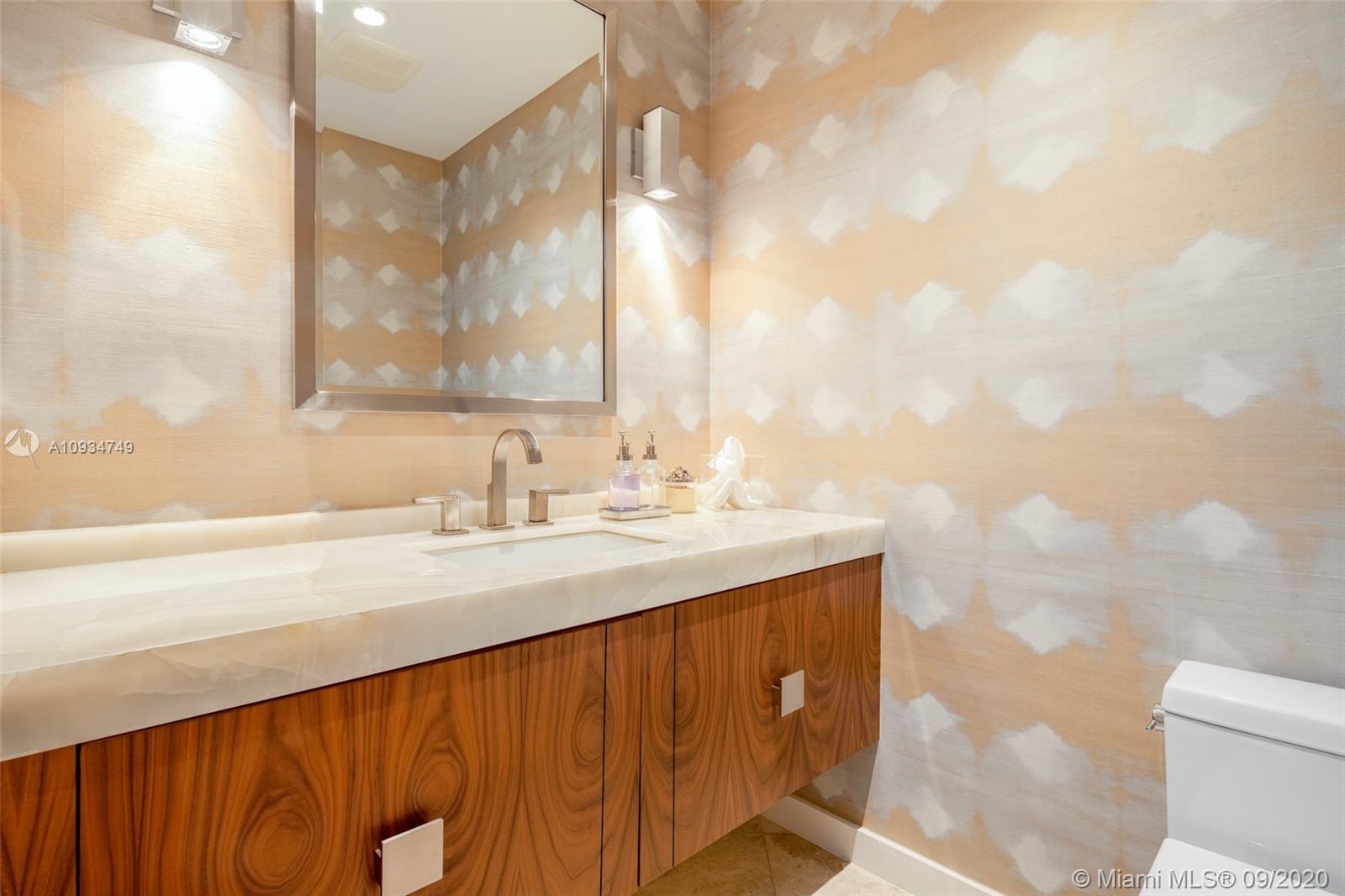 4301 Bay Point Road Miami, FL 33137 - Photo 28 of 33 a bathroom with a sink and a mirror