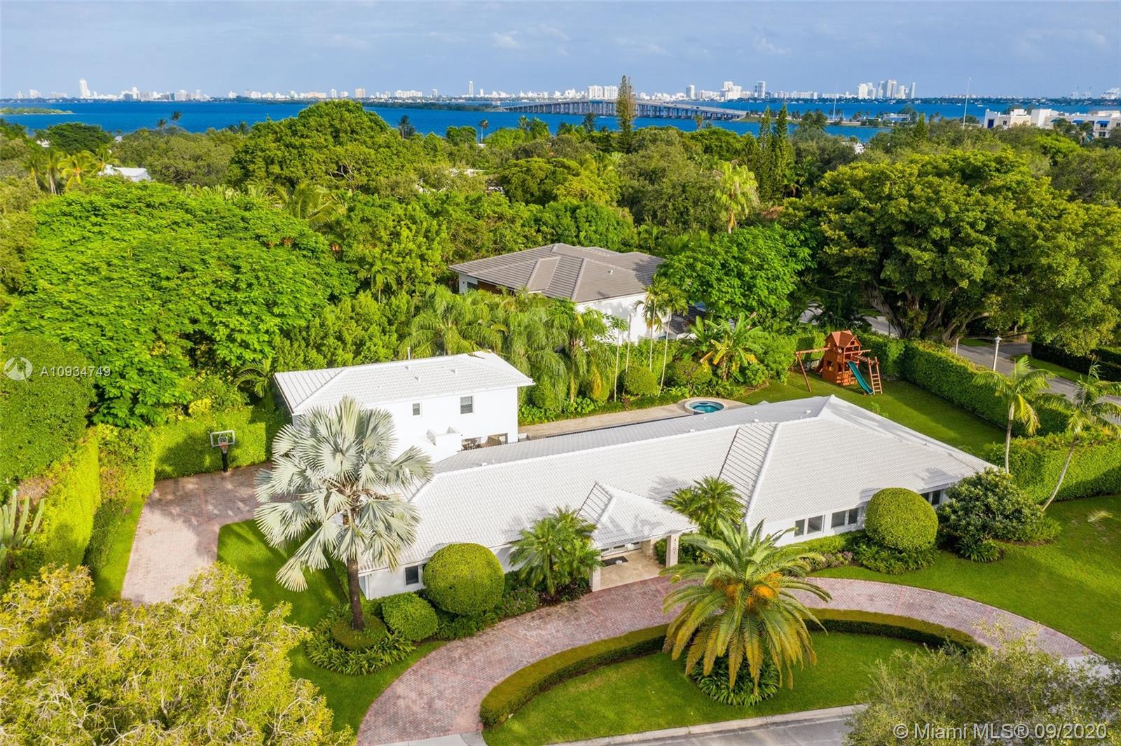 4301 Bay Point Road Miami, FL 33137 - Photo 33 of 33 a view of a swimming pool with a garden and plants