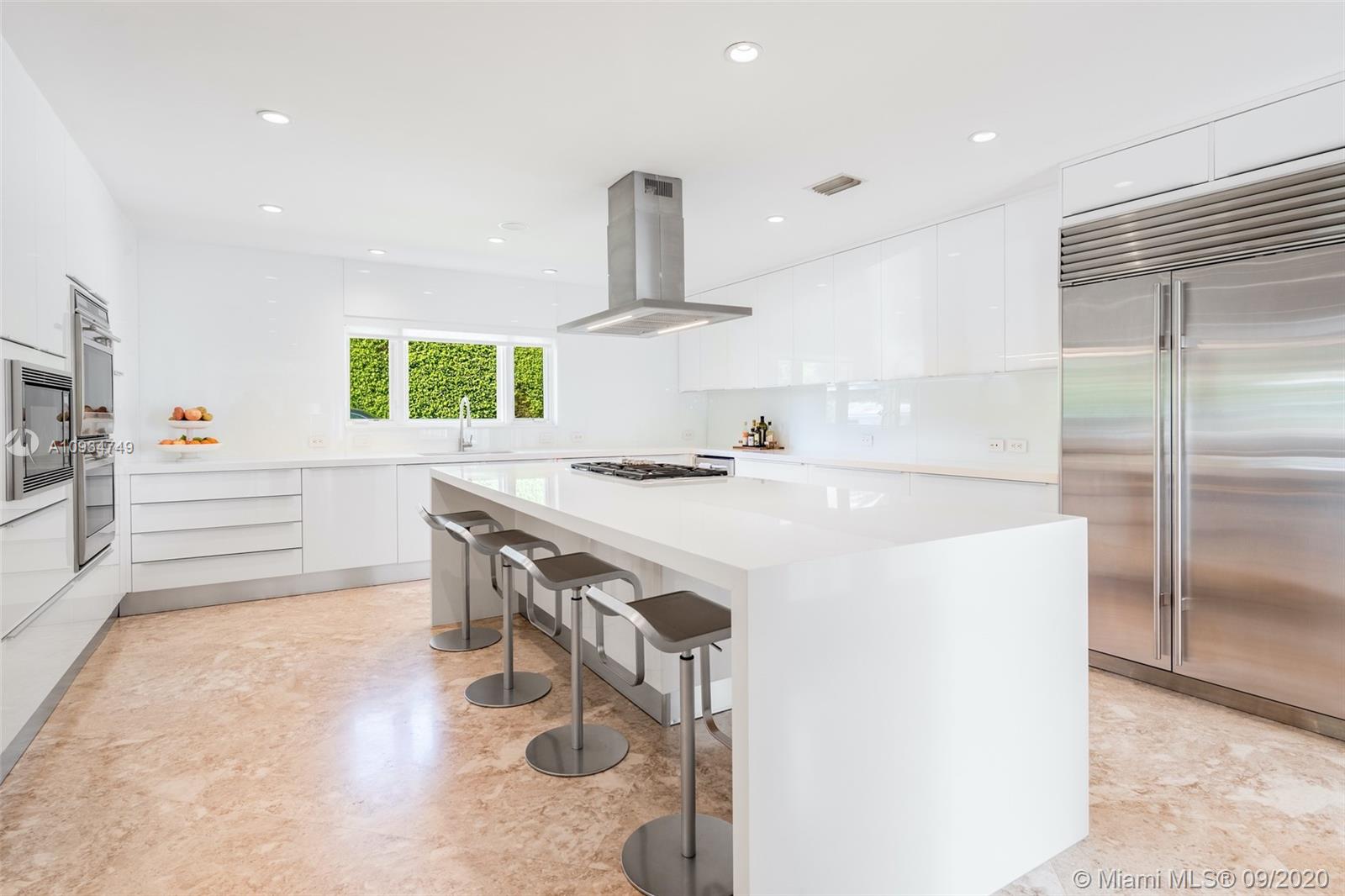 4301 Bay Point Road Miami, FL 33137 - Photo 4 of 33 a kitchen with stainless steel appliances a sink and a refrigerator