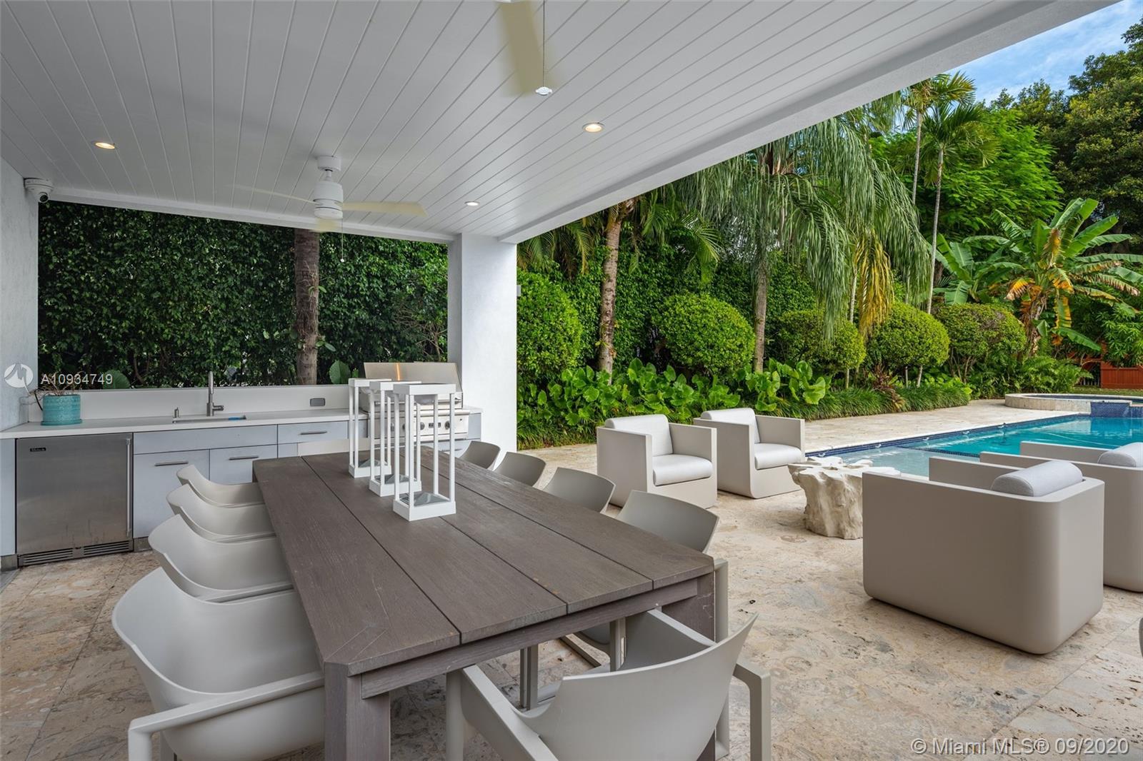 4301 Bay Point Road Miami, FL 33137 - Photo 7 of 33 a outdoor dining space with furniture and garden view