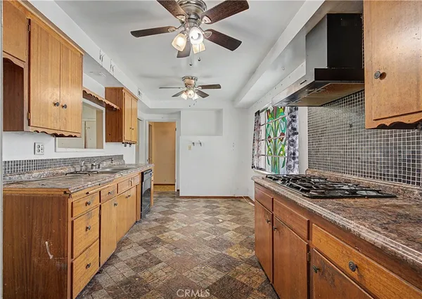 a kitchen with stainless steel appliances granite countertop a stove and cabinets