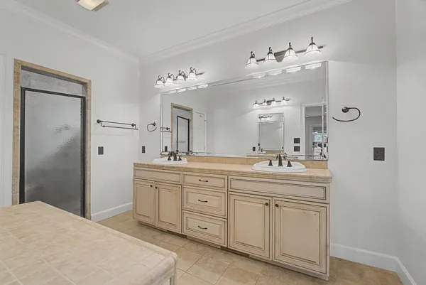 a spacious bathroom with a double vanity sink and a mirror