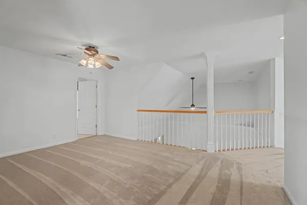 a view of a room with wooden floor