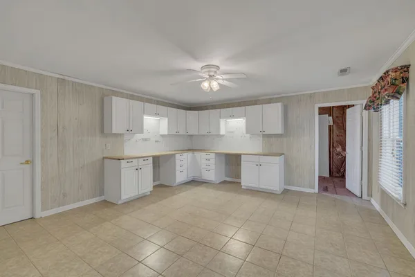 a view of kitchen with furniture and a ceiling fan