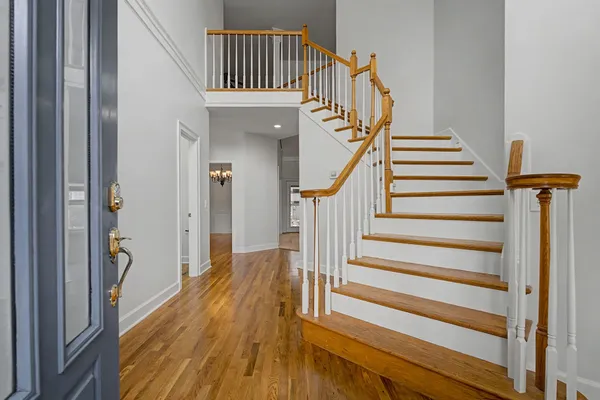 a view of entryway and hall with wooden floor
