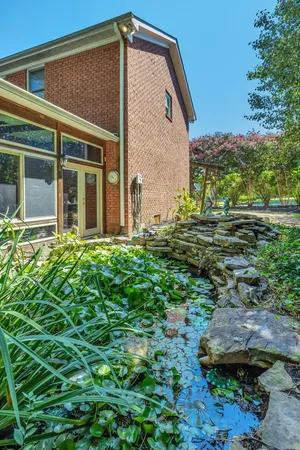 a view of a house with backyard and sitting area
