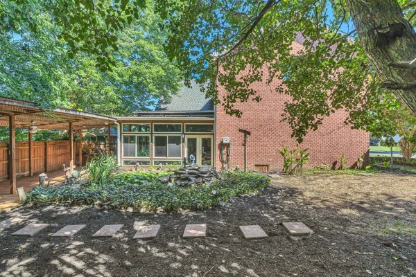 a view of house with backyard