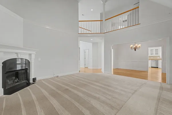 a view of empty room with fireplace and fan