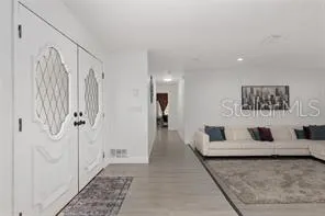 a living room with furniture and large window
