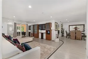 a living room with furniture a large window and gym equipment