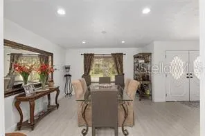 a kitchen with granite countertop white cabinets and white stainless steel appliances