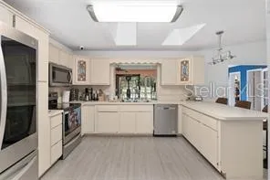 a kitchen with a refrigerator and a sink