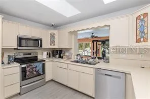 a living room with fireplace furniture and a chandelier