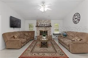 a large kitchen with cabinets chairs and stainless steel appliances