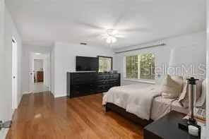 a bathroom with a granite countertop sink mirror and toilet