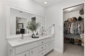 a view of walk in closet with clothes and shoes