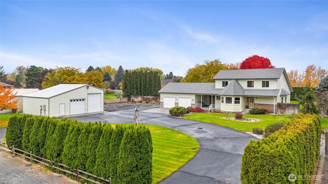 a view of a house with swimming pool and a yard