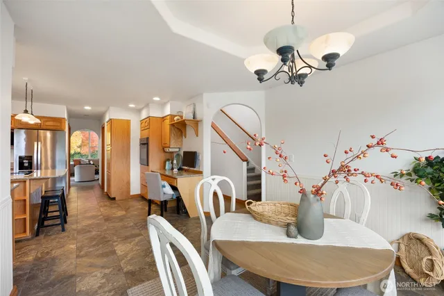 a living room with furniture flowerpot and a chandelier