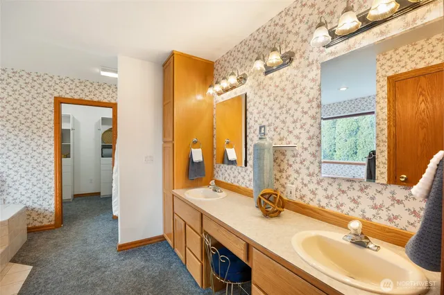 a bathroom with a granite countertop sink mirror and double