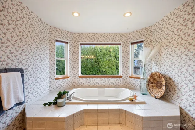 a bath tub sitting in a bathroom next to a window