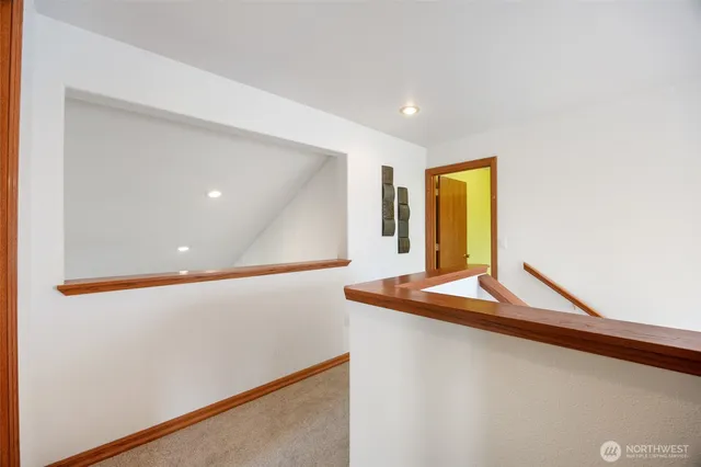 a view of a hallway with paintings on the wall