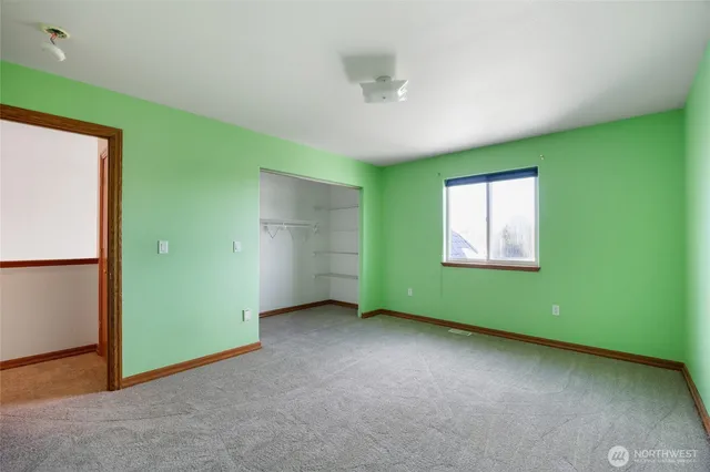 an empty room with closet area