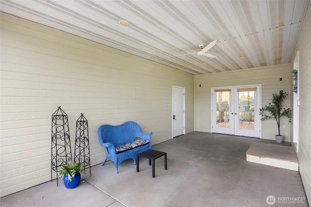 a view of a chair and tables in the patio