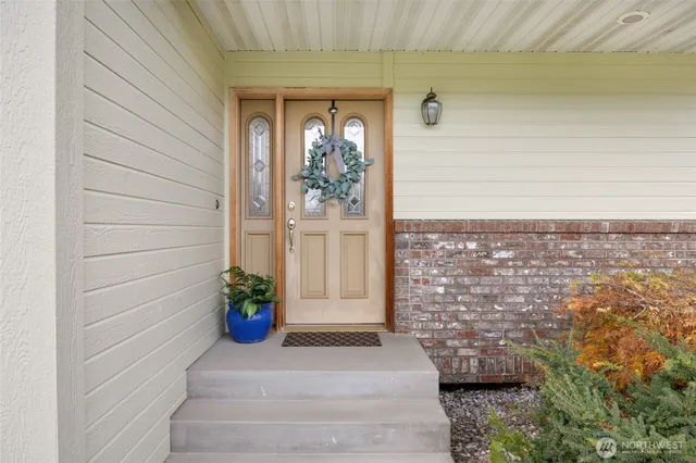 a front view of a house with a potted plant