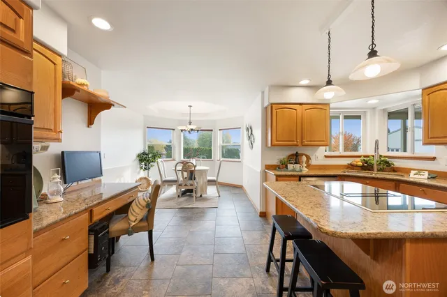 a large kitchen with a table and chairs in it
