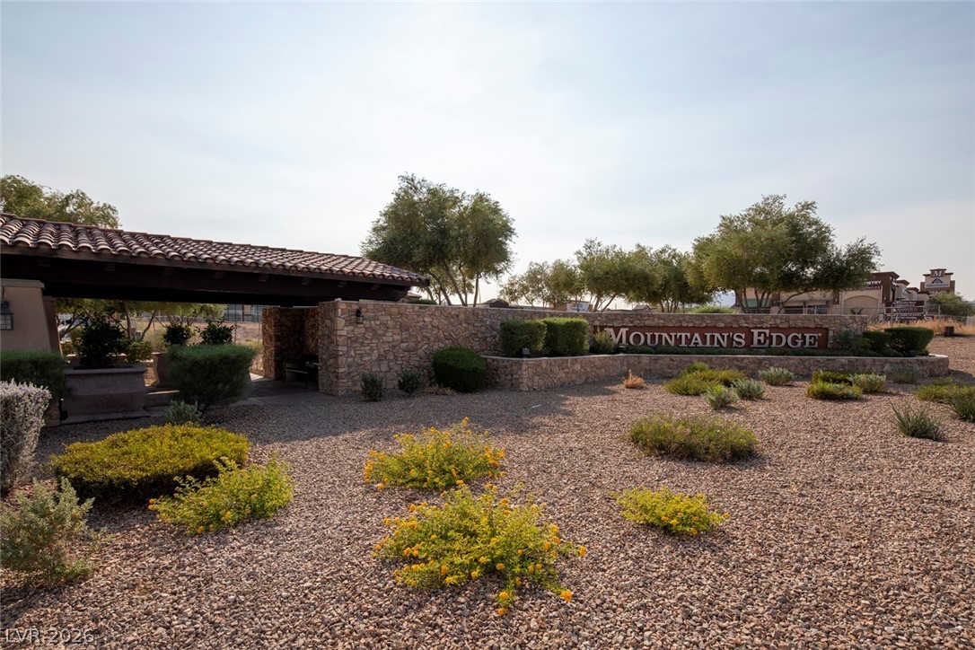 7375 Campbell Ranch Avenue Las Vegas, NV 89179 - Photo 41 of 45 Enter the tranquil Mountain's Edge community, marked by a distinguished stone and tile entrance.