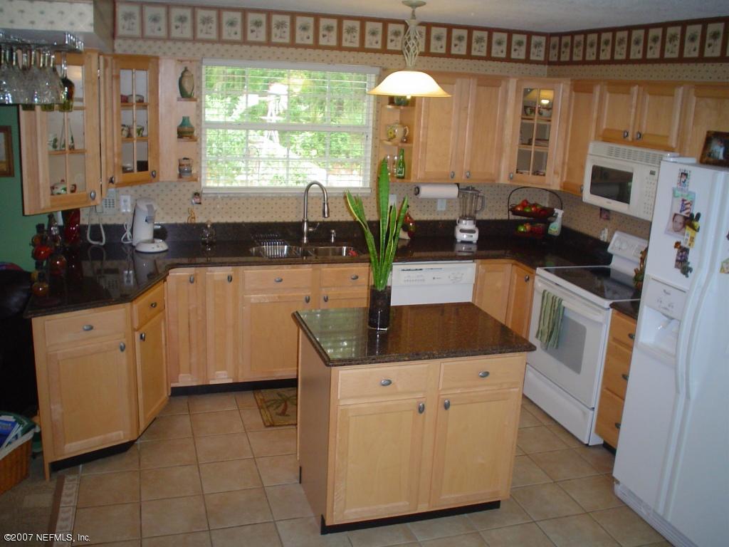 1497 Satsuma Road Jacksonville, FL 32259 - Photo 3 of 9 a kitchen with stainless steel appliances granite countertop a stove a sink and a refrigerator
