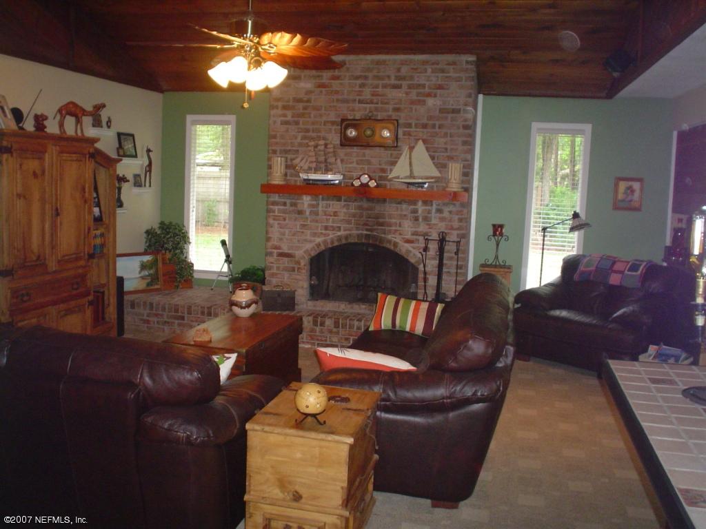 1497 Satsuma Road Jacksonville, FL 32259 - Photo 9 of 9 a living room with furniture and a fireplace