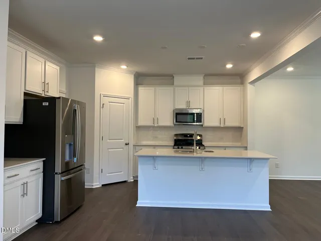 a kitchen with stainless steel appliances a refrigerator stove microwave and sink