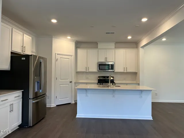 a kitchen with stainless steel appliances a refrigerator stove microwave and sink