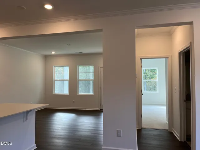 a view of a livingroom with wooden floor and a window