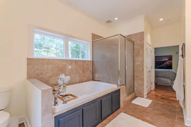 a spacious bathroom with a granite countertop sink a toilet and shower