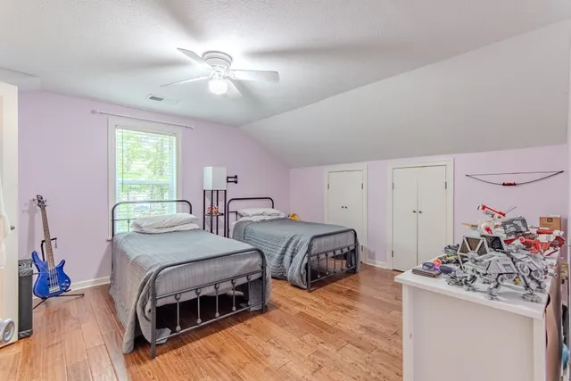 a bedroom with a bed and a chandelier