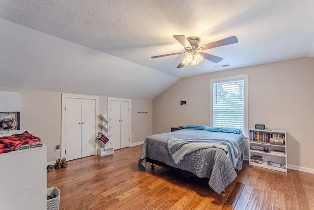 a bedroom with a bed and a chandelier