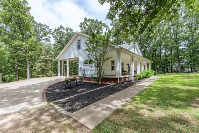 a house view with a sitting space and garden