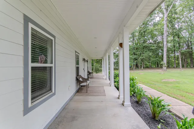 a view of a house with backyard and porch