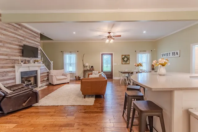 a living room with fireplace furniture and a wooden floor