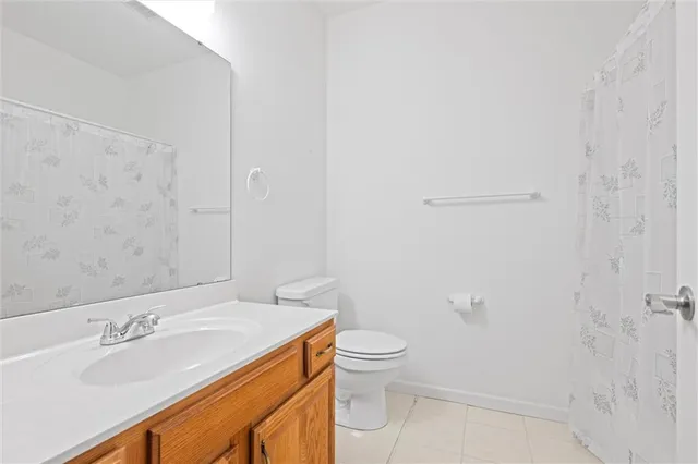 an empty room with closet and a chandelier fan